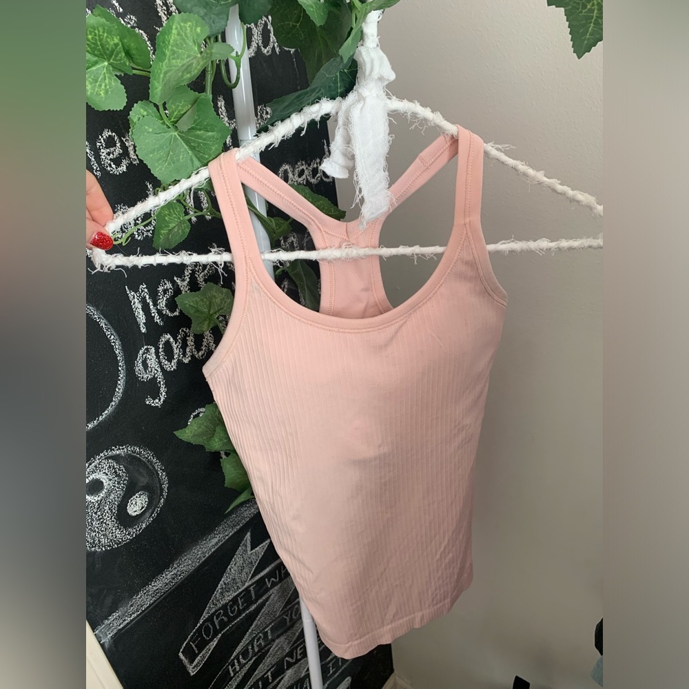 Light pink Ebb to the Street Lululemon tank. Light support b/c cup. Size 2